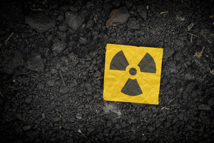Radiation warning sign on soil background